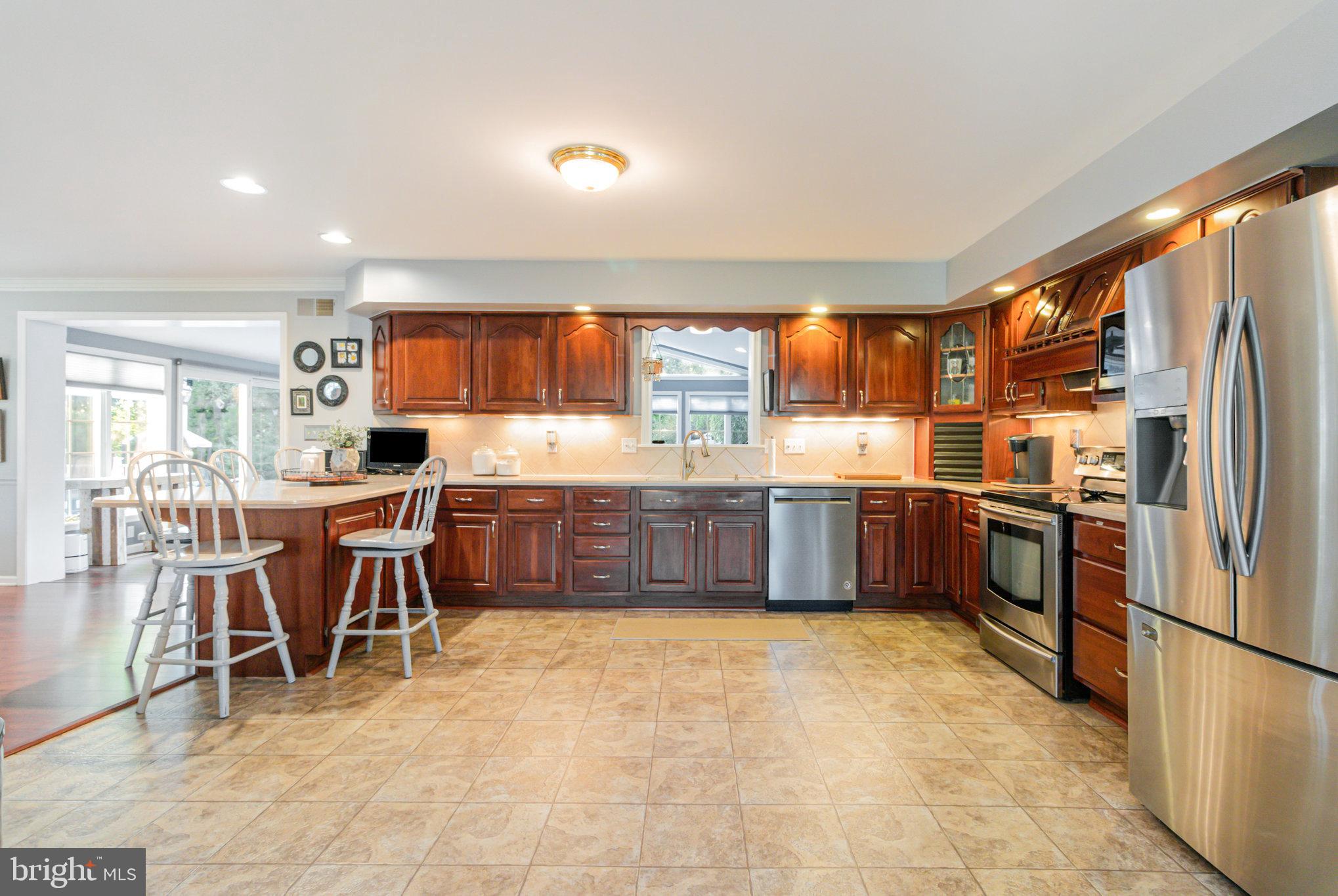 124 South Ridge Road Boiling Springs, PA 17007 - Photo 8 of 56 a kitchen with stainless steel appliances a sink a stove a refrigerator cabinets and a dining table