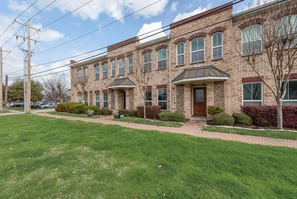 a front view of a building with a garden