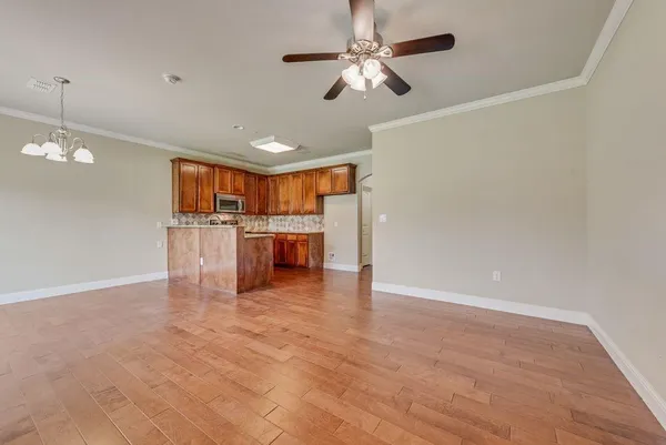 a view of a kitchen with a microwave and a ceiling fan