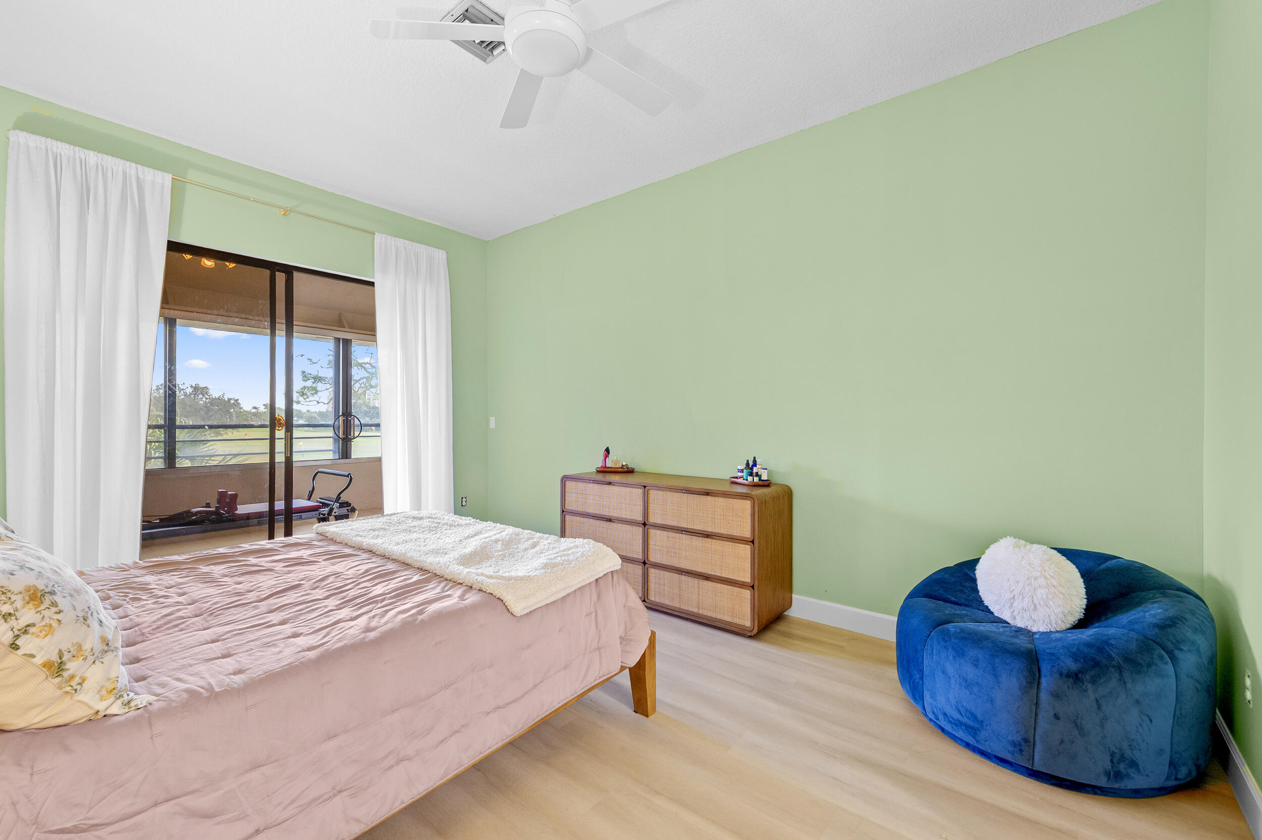 7460 La Paz Boulevard, Unit 304 Boca Raton, FL 33433 - Photo 13 of 37 a bedroom with a bed and a chandelier