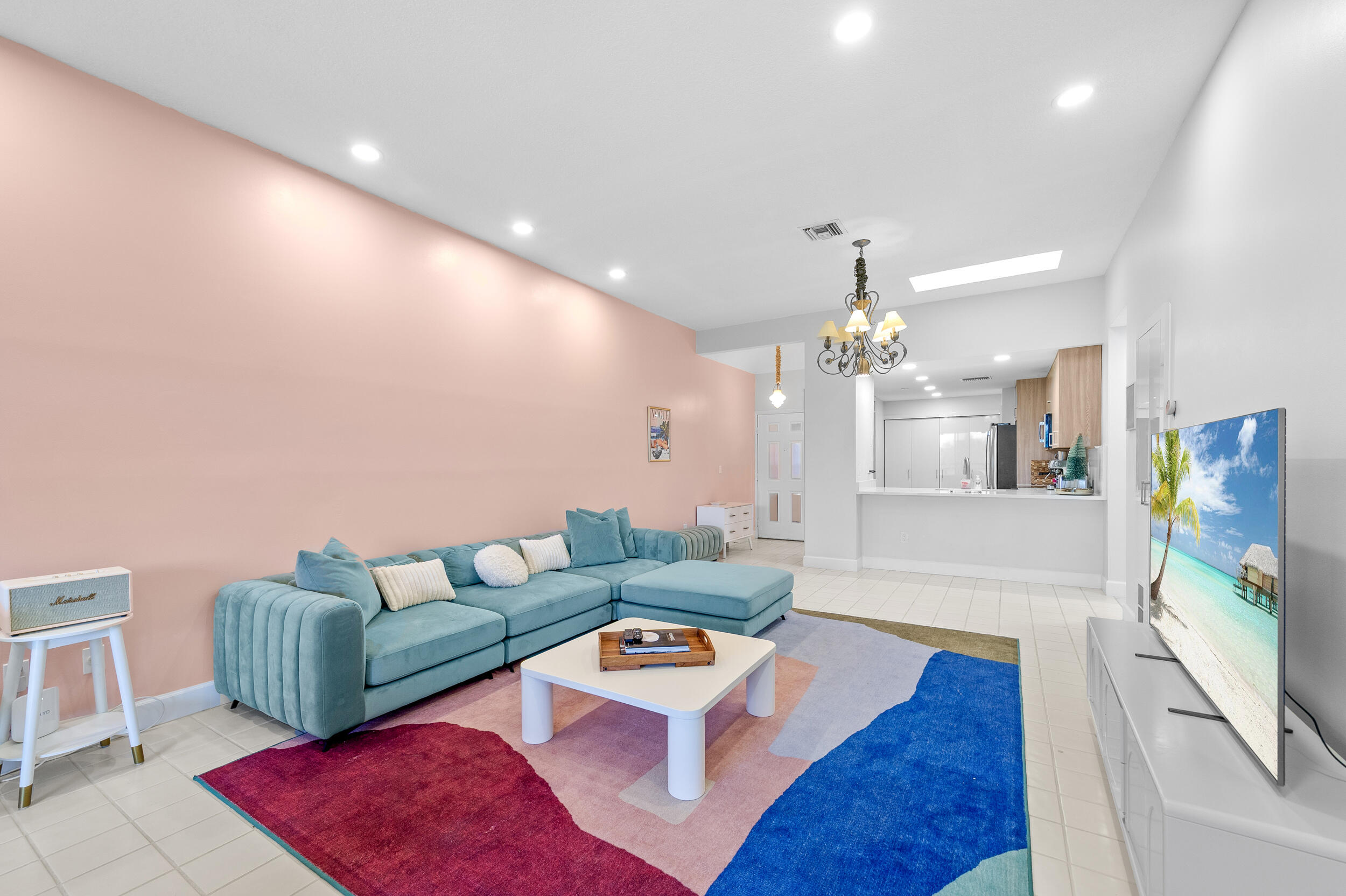 7460 La Paz Boulevard, Unit 304 Boca Raton, FL 33433 - Photo 19 of 37 a living room with furniture and a flat screen tv