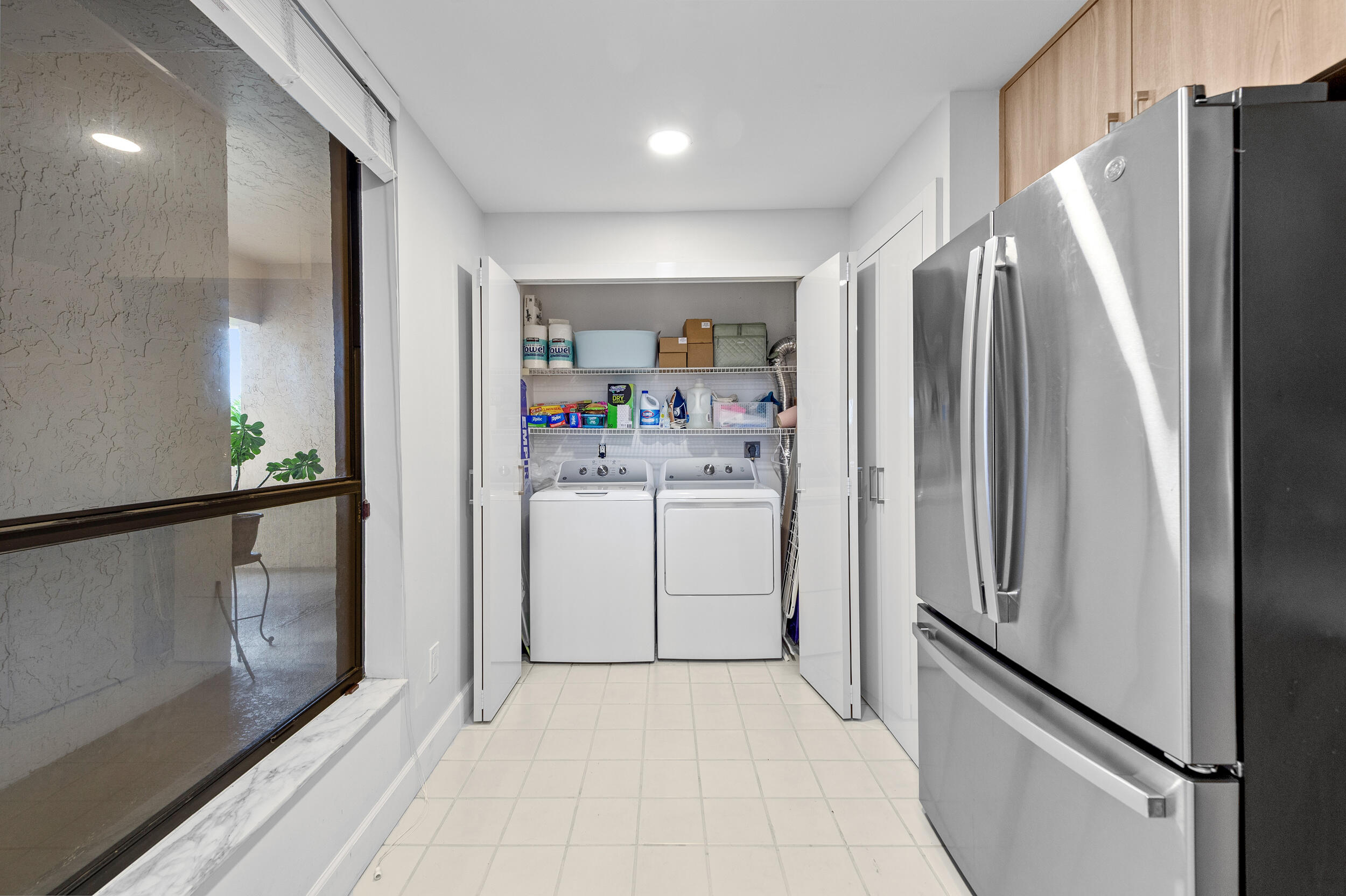7460 La Paz Boulevard, Unit 304 Boca Raton, FL 33433 - Photo 26 of 37 a kitchen with a refrigerator and a refrigerator