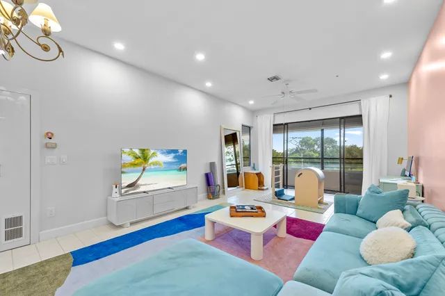 a living room with furniture and a potted plant