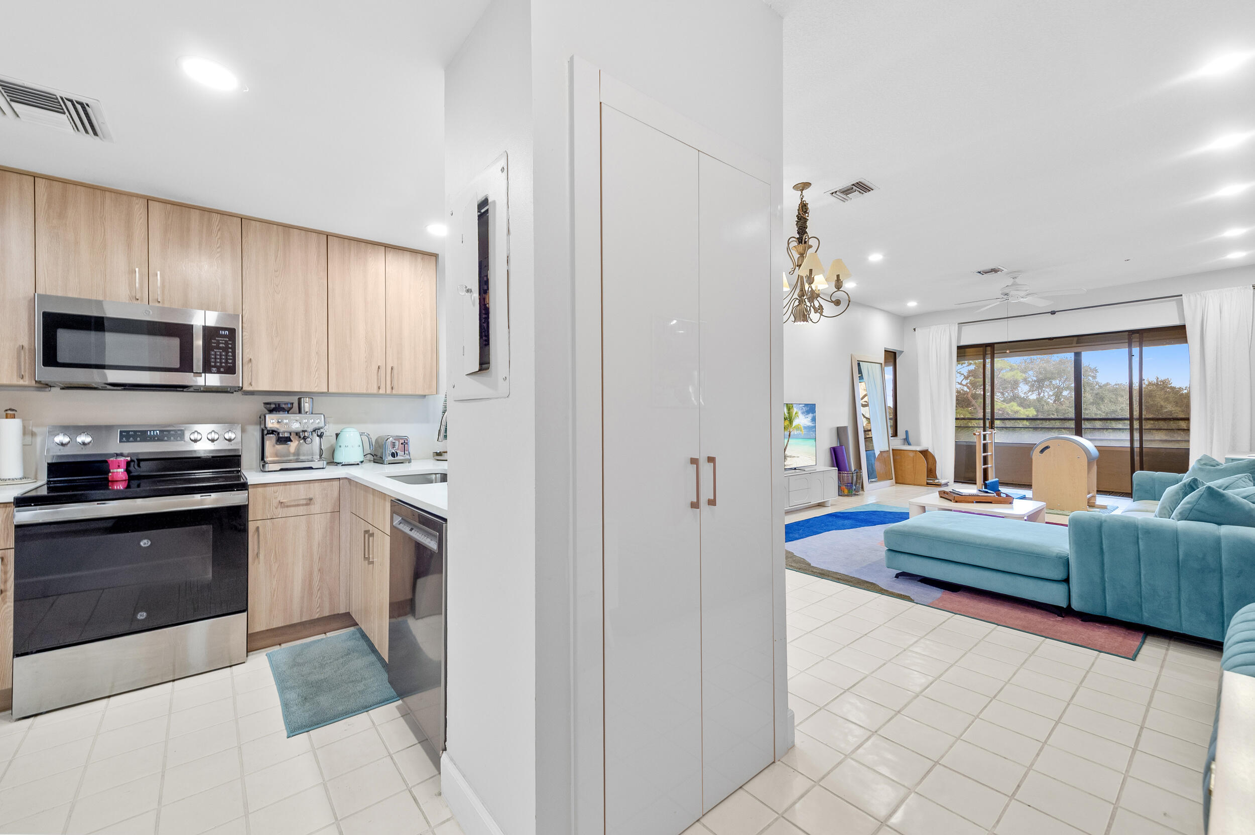 7460 La Paz Boulevard, Unit 304 Boca Raton, FL 33433 - Photo 4 of 37 a kitchen with granite countertop lots of counter top space and stainless steel appliances