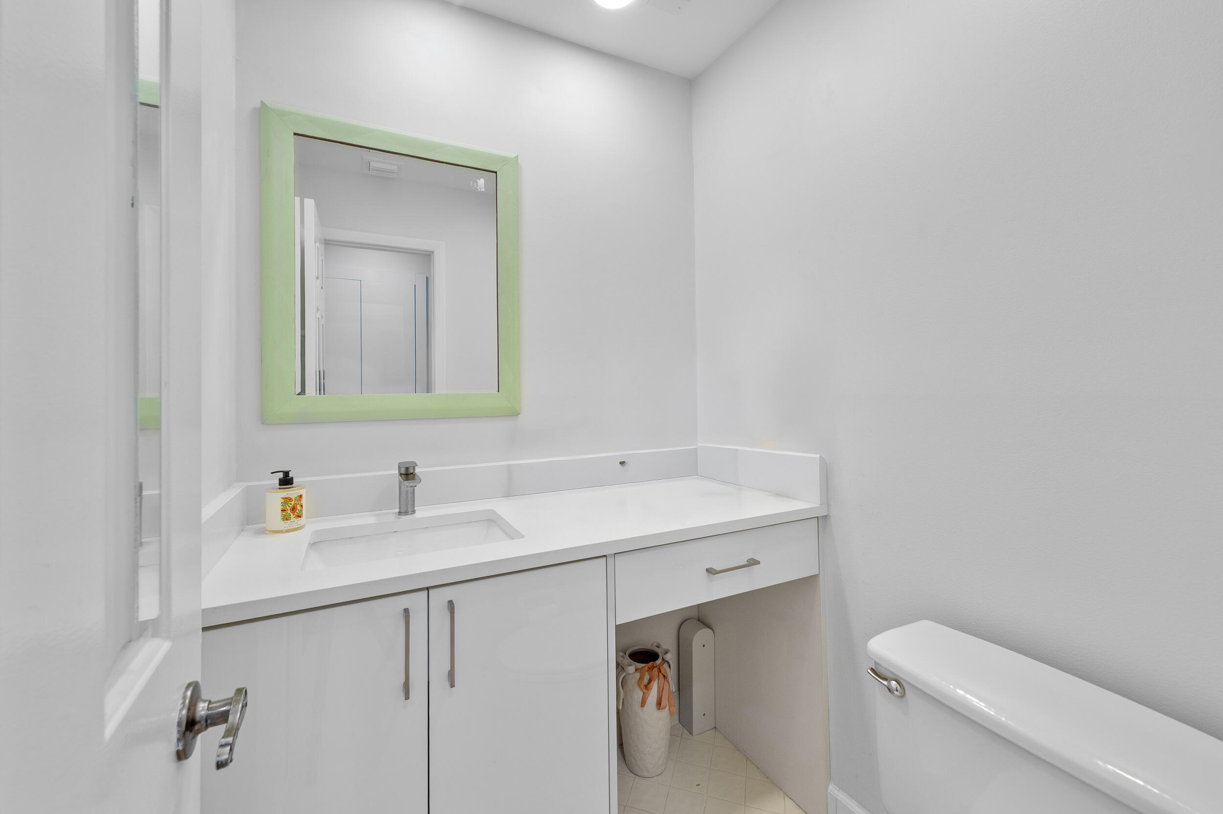 7460 La Paz Boulevard, Unit 304 Boca Raton, FL 33433 - Photo 7 of 37 a bathroom with a toilet sink and mirror