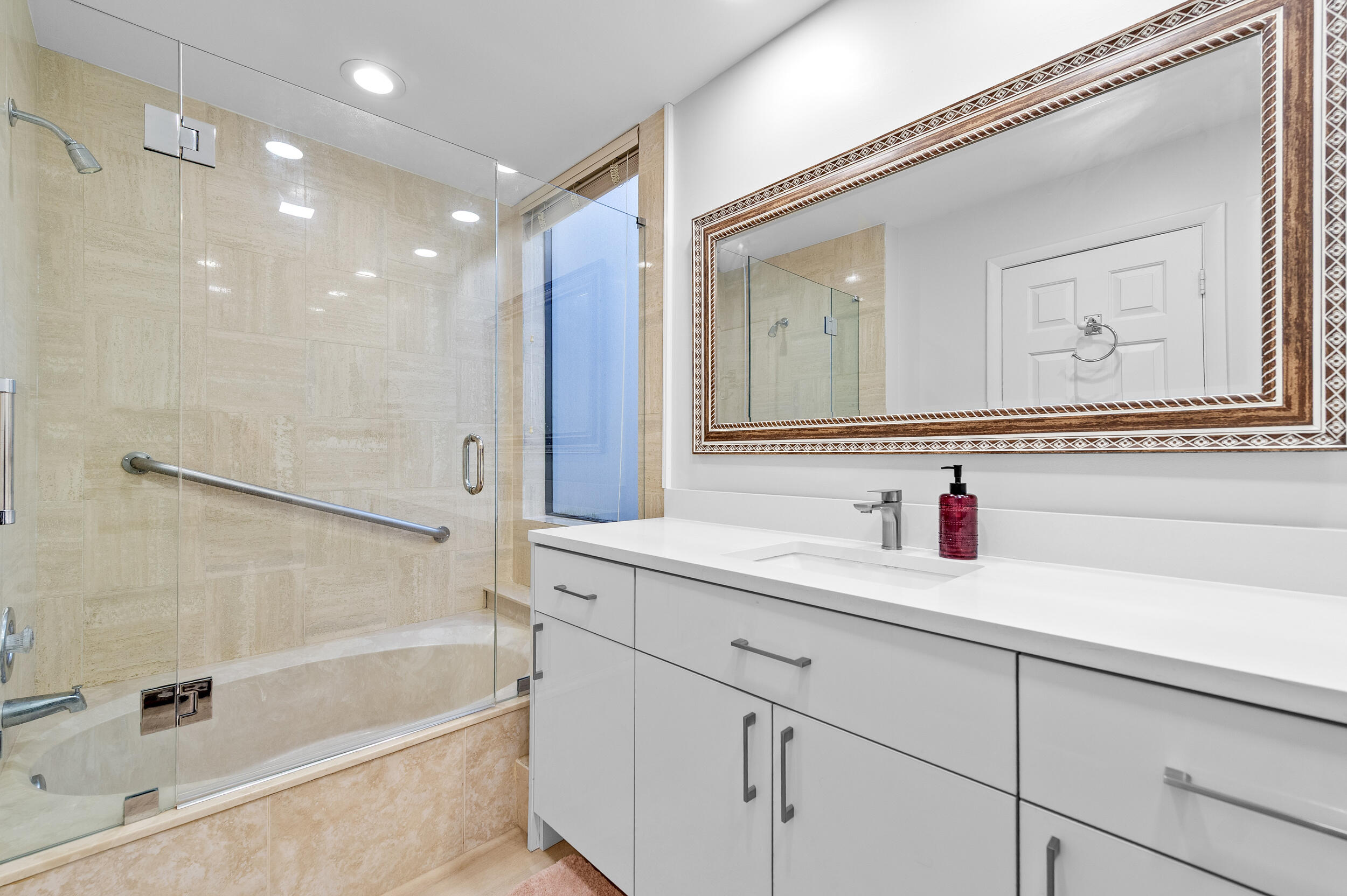 7460 La Paz Boulevard, Unit 304 Boca Raton, FL 33433 - Photo 8 of 37 a bathroom with a bathtub and a sink