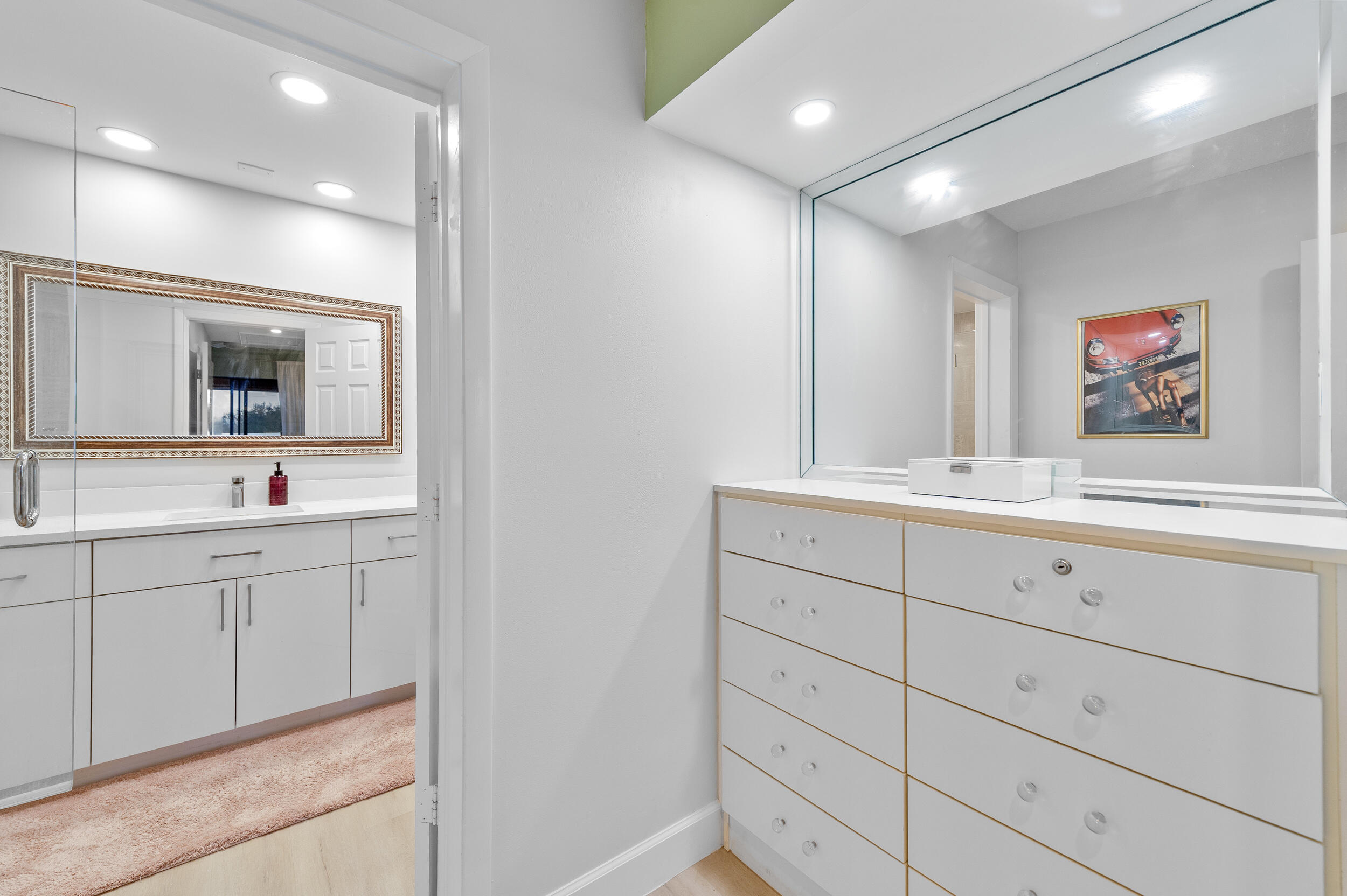 7460 La Paz Boulevard, Unit 304 Boca Raton, FL 33433 - Photo 10 of 37 a bathroom with a sink mirror and vanity