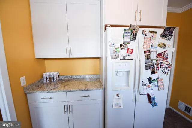 a bathroom with a refrigerator and a sink
