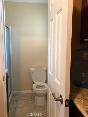 a white toilet sitting next to a shower curtain