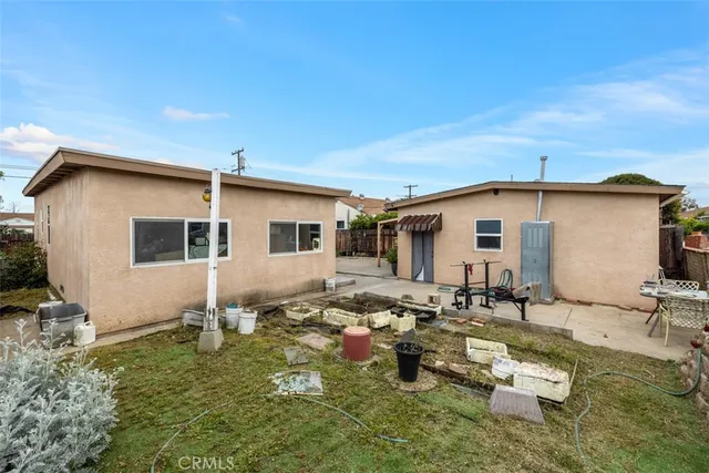 a backyard of a house with outdoor seating