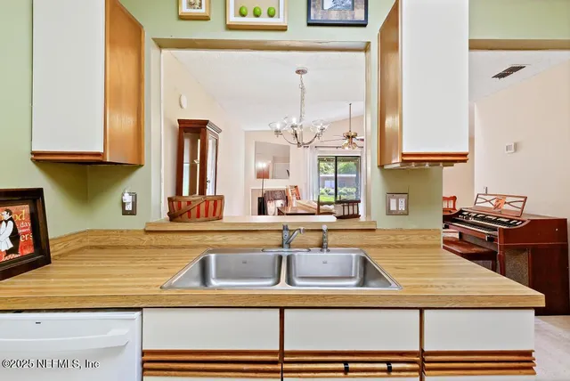 a kitchen with a refrigerator and a sink