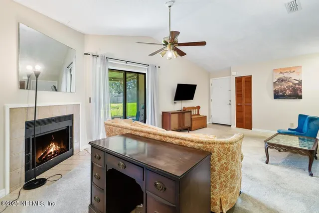 a living room with furniture and a flat screen tv
