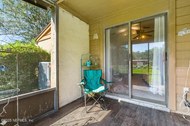 a view of a porch with furniture and garden