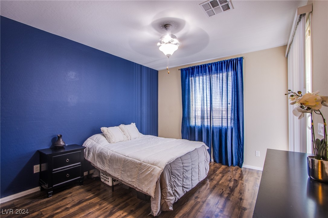 6106 Andover Wood Road Las Vegas, NV 89113 - Photo 33 of 49 Casita private and spacious bedroom with custom paint, manmade wood flooring, ceiling fan, walk-in closet and private egress/entry to back yard retreat.