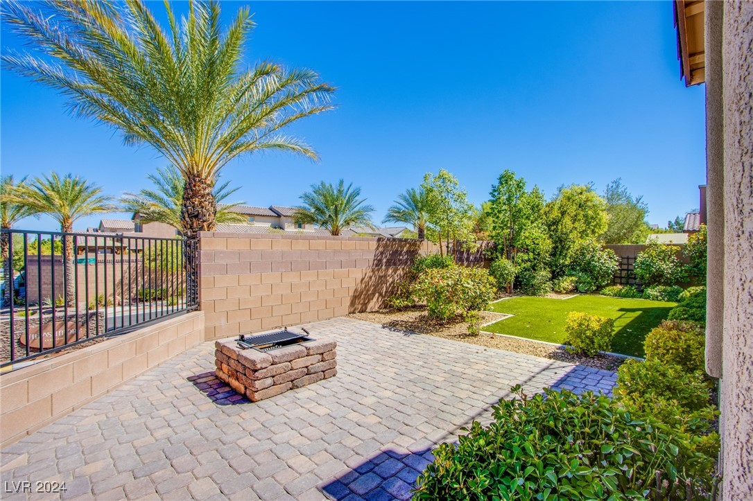 6106 Andover Wood Road Las Vegas, NV 89113 - Photo 39 of 49 Beautiful low maintenance landscaped backyard w/turf, covered patio, pavers and fire pit courtyard area w/pavers. Entry to main house kitchen and private entrance to Casita.