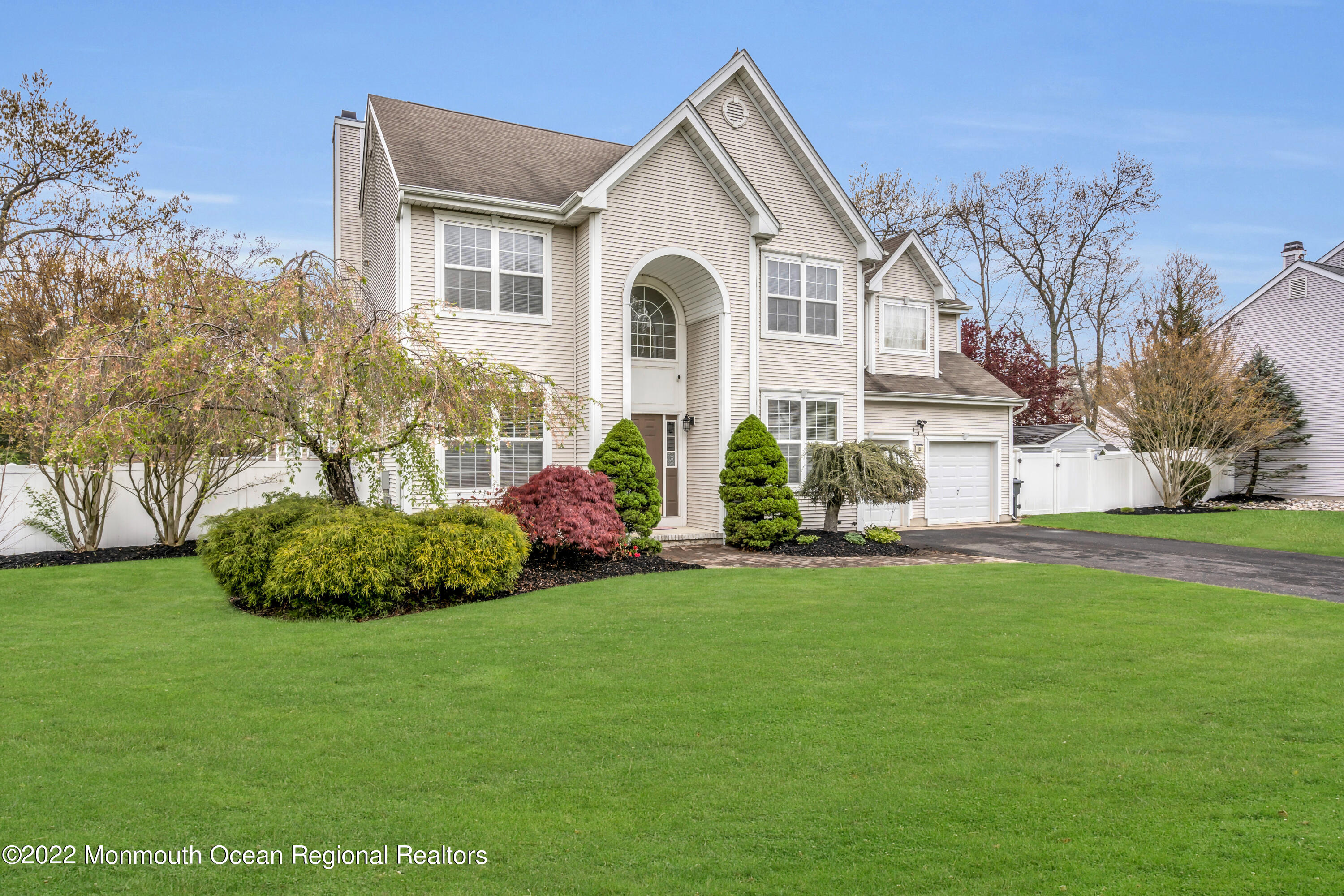 a front view of a house with a garden and plants