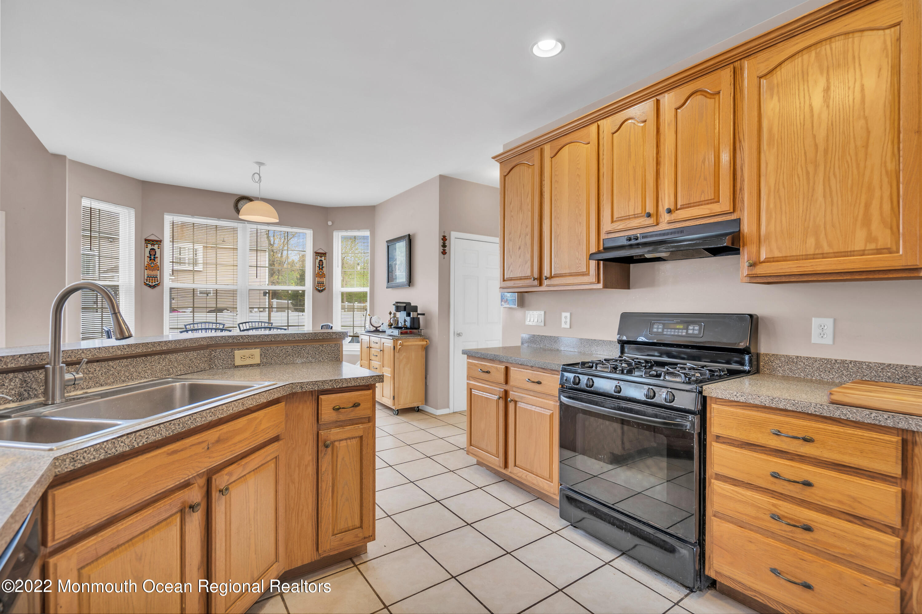 131 Nobility Court Toms River, NJ 08755 - Photo 22 of 60 a kitchen with stainless steel appliances granite countertop a stove sink and cabinets