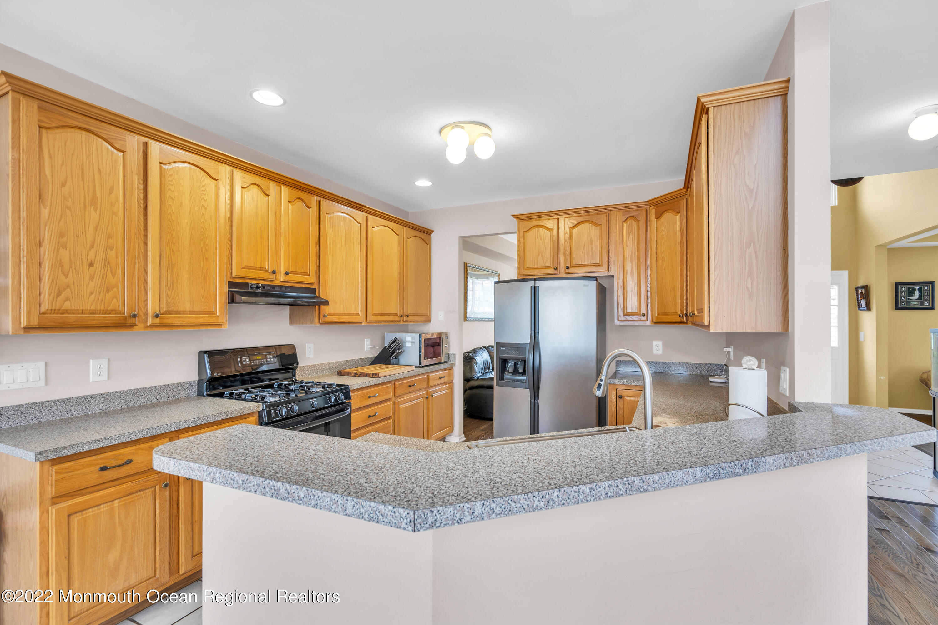 131 Nobility Court Toms River, NJ 08755 - Photo 26 of 60 a kitchen with stainless steel appliances granite countertop sink stove and refrigerator