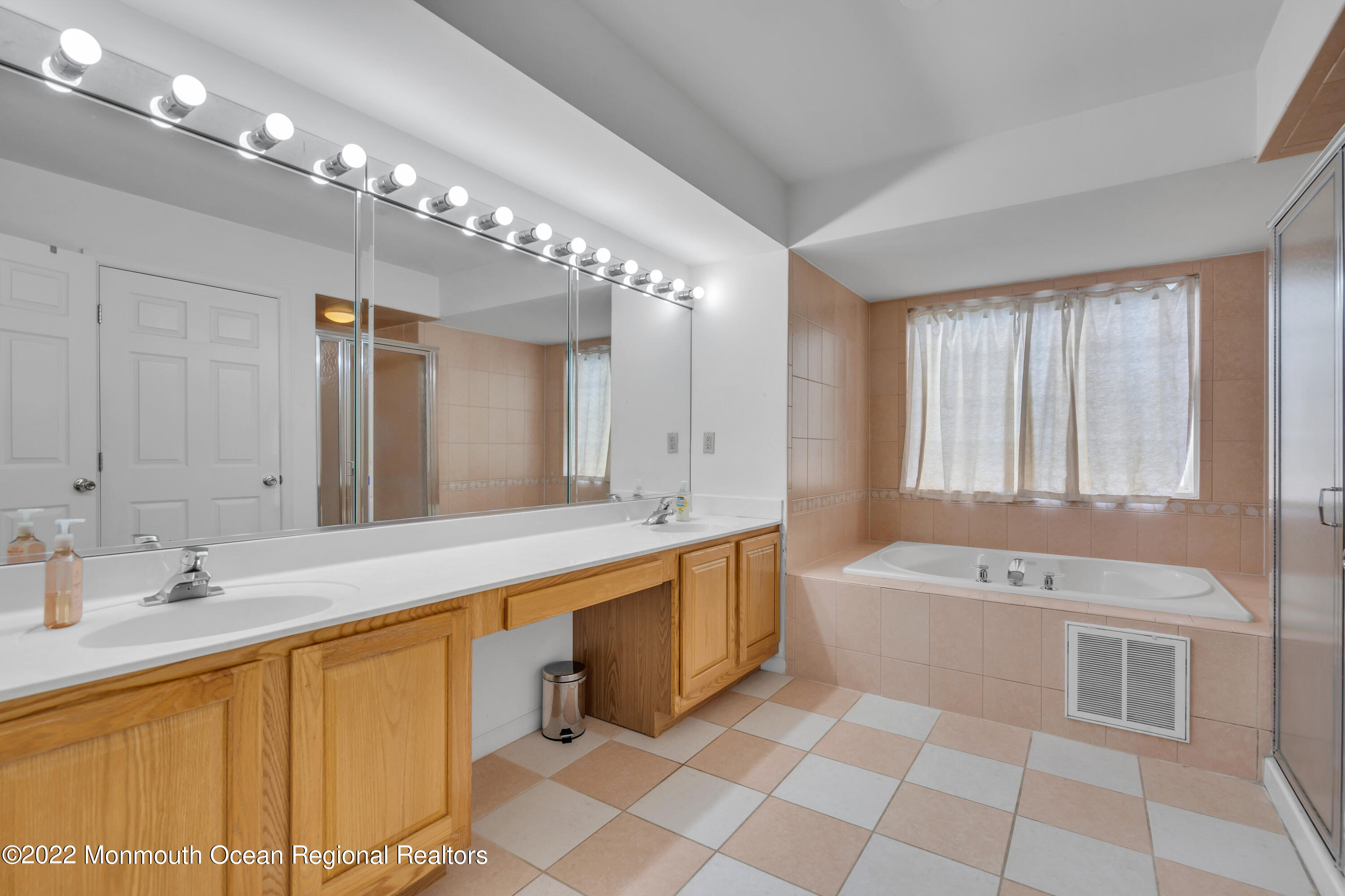 131 Nobility Court Toms River, NJ 08755 - Photo 38 of 60 a spacious bathroom with a double vanity sink a large mirror and a bathtub