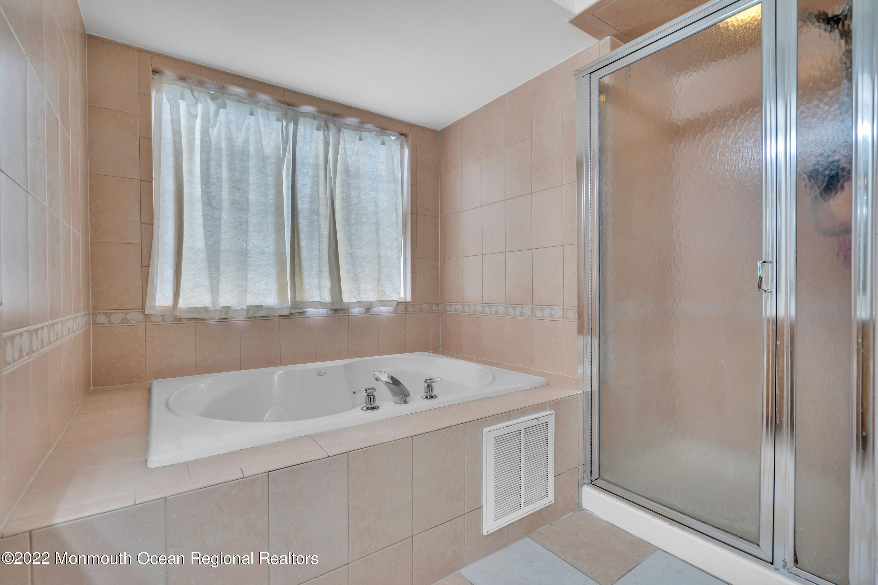 131 Nobility Court Toms River, NJ 08755 - Photo 39 of 60 a white bath tub sitting in a en suite bathroom