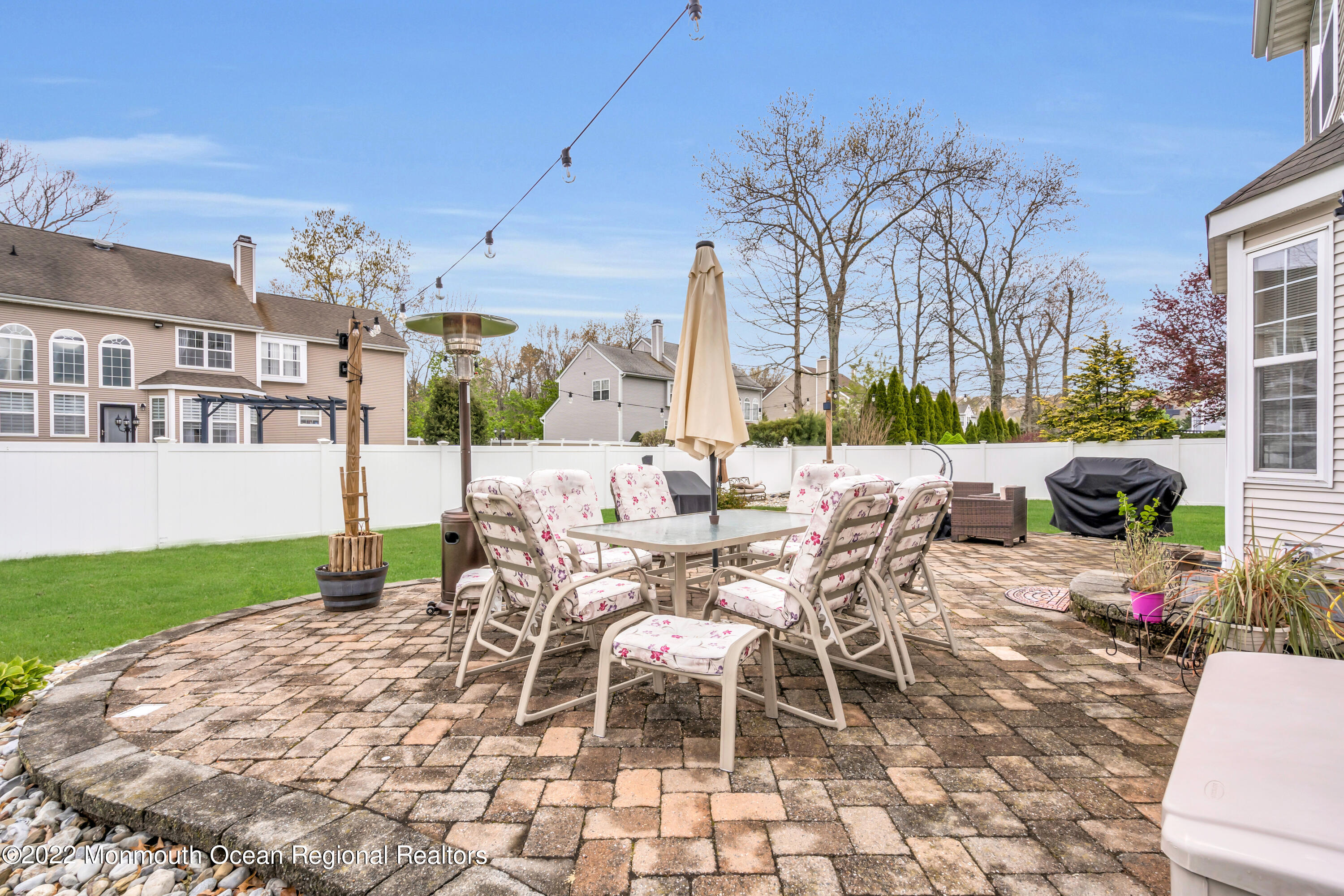 131 Nobility Court Toms River, NJ 08755 - Photo 49 of 60 a view of a patio with a dining table and chairs with wooden floor