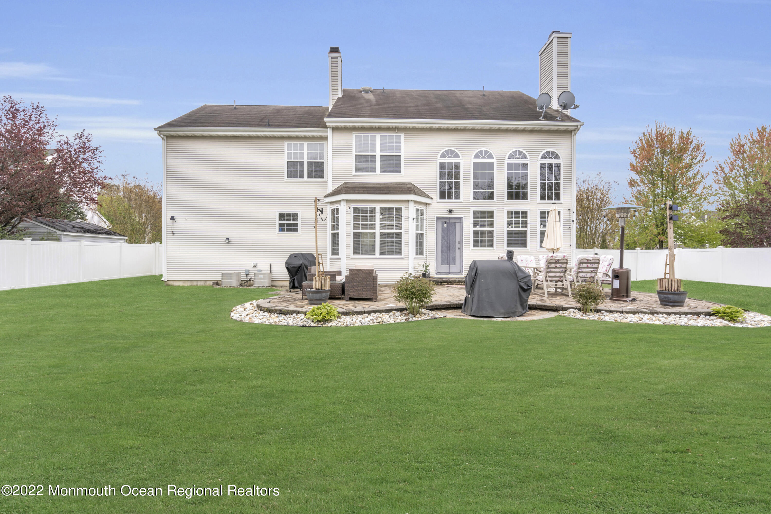 131 Nobility Court Toms River, NJ 08755 - Photo 50 of 60 a front view of a house with a garden and yard