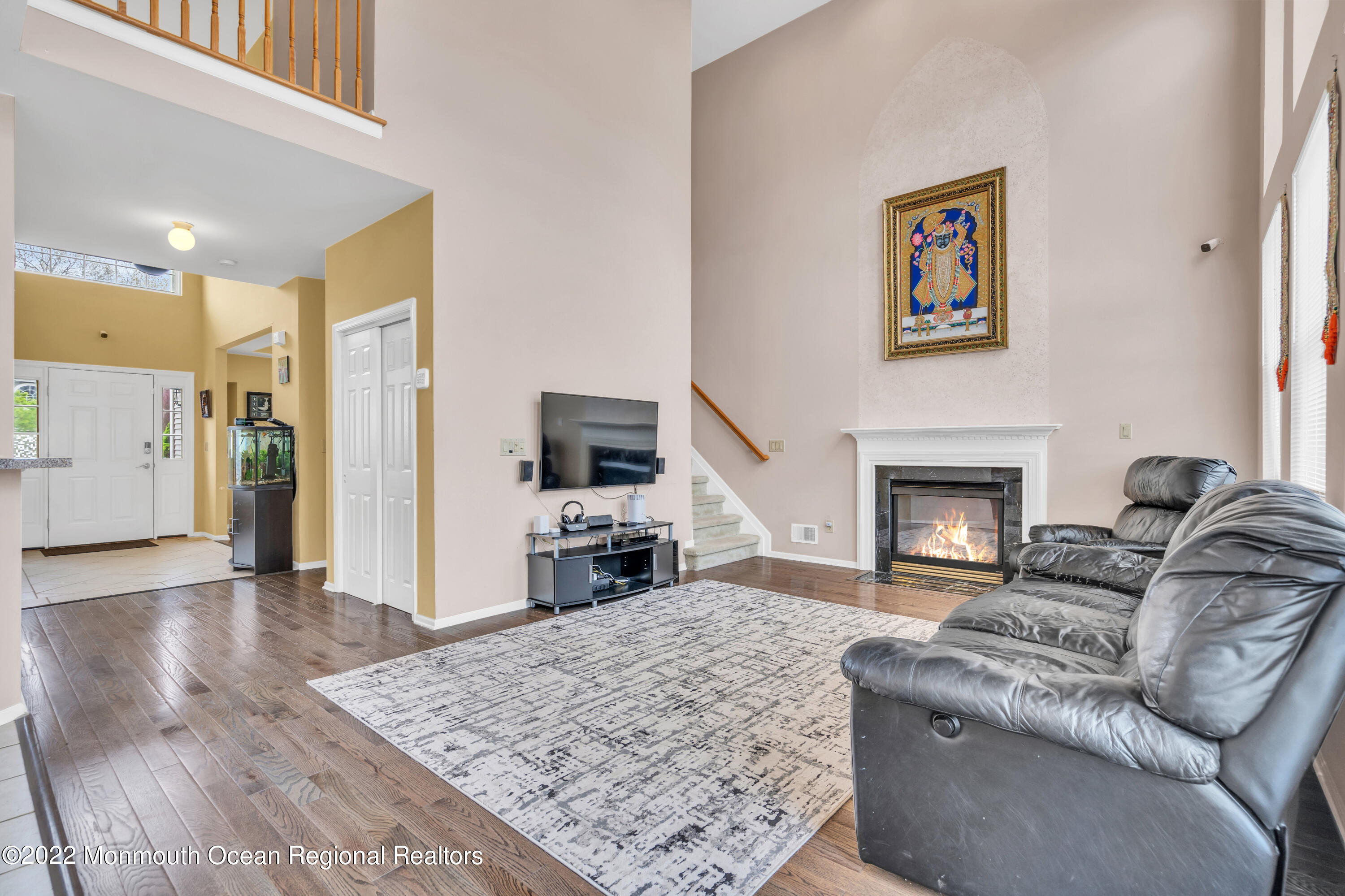 131 Nobility Court Toms River, NJ 08755 - Photo 10 of 60 a living room with furniture a flat screen tv and a fireplace