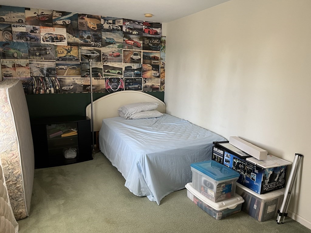 15 Progress Street Fall River, MA 02721 - Photo 11 of 30 a bedroom with a bed and a chandelier