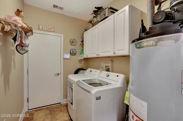 a spacious bedroom with a bed and a flat screen tv