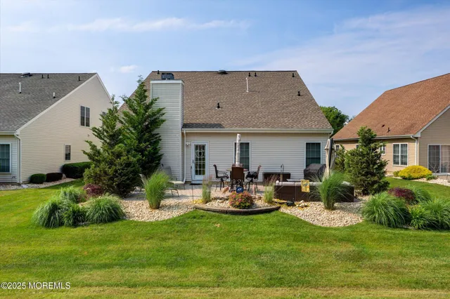 an aerial view of residential houses with outdoor space and trees