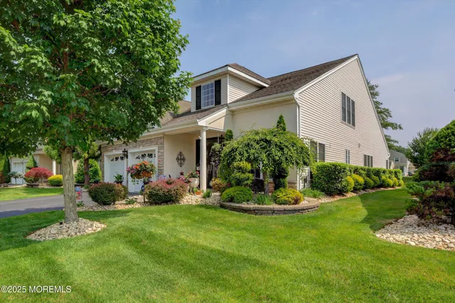 a front view of house with a garden and yard