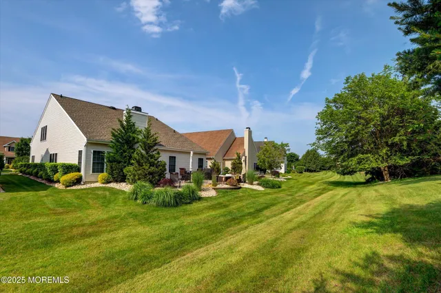 an aerial view of a house with garden space and street view