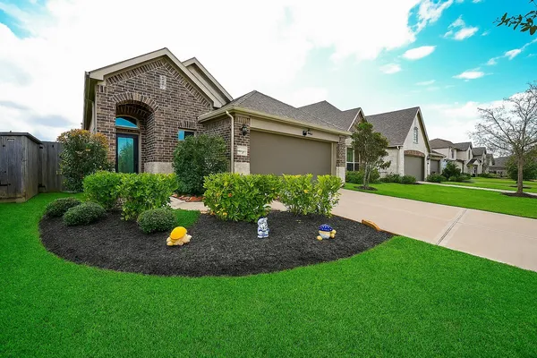 a front view of a house with a garden