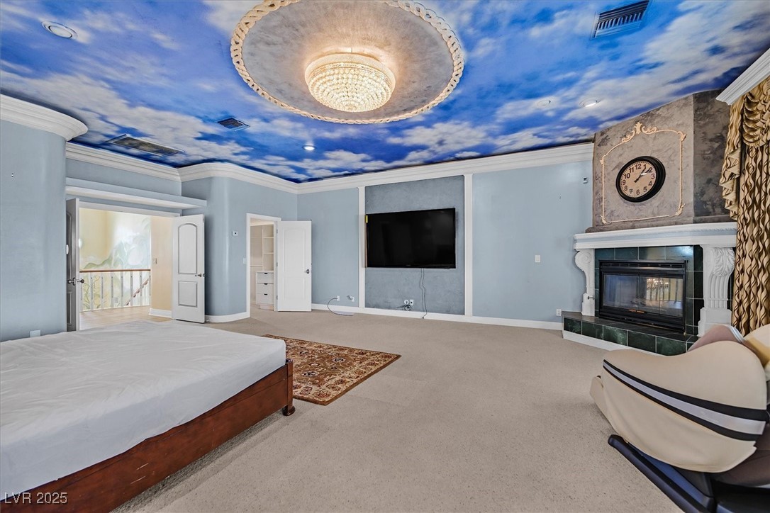 3372 Westwind Road Las Vegas, NV 89146 - Photo 11 of 39 Bedroom with ornamental molding, carpet flooring, and a fireplace