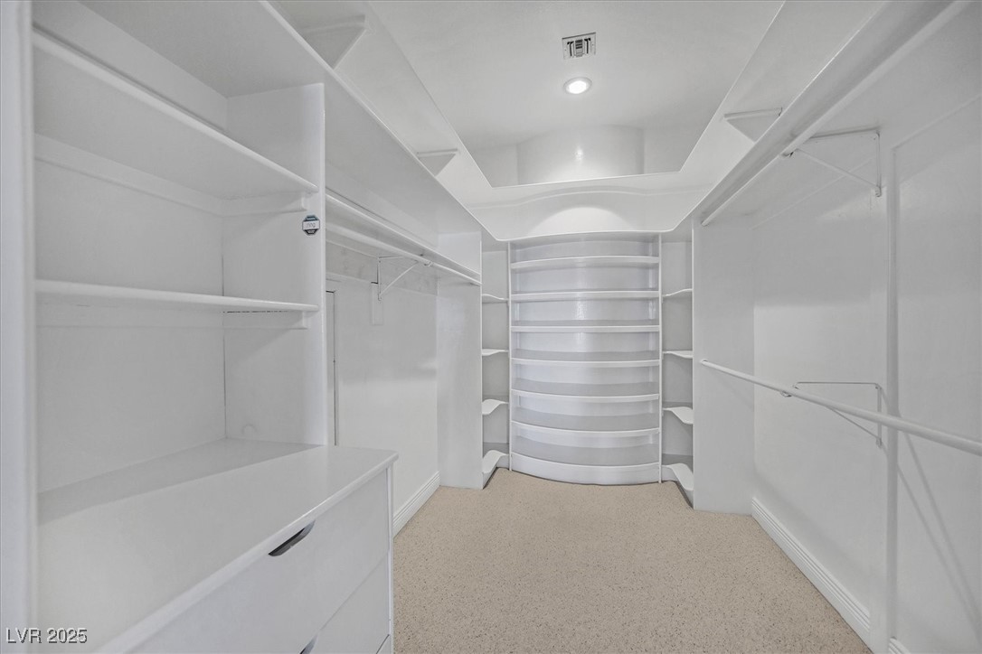 3372 Westwind Road Las Vegas, NV 89146 - Photo 19 of 39 Walk in closet featuring light carpet