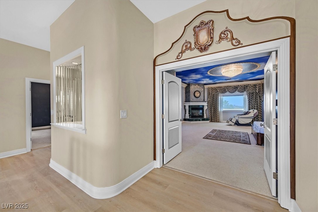3372 Westwind Road Las Vegas, NV 89146 - Photo 35 of 39 Hallway with baseboards and light wood-style flooring