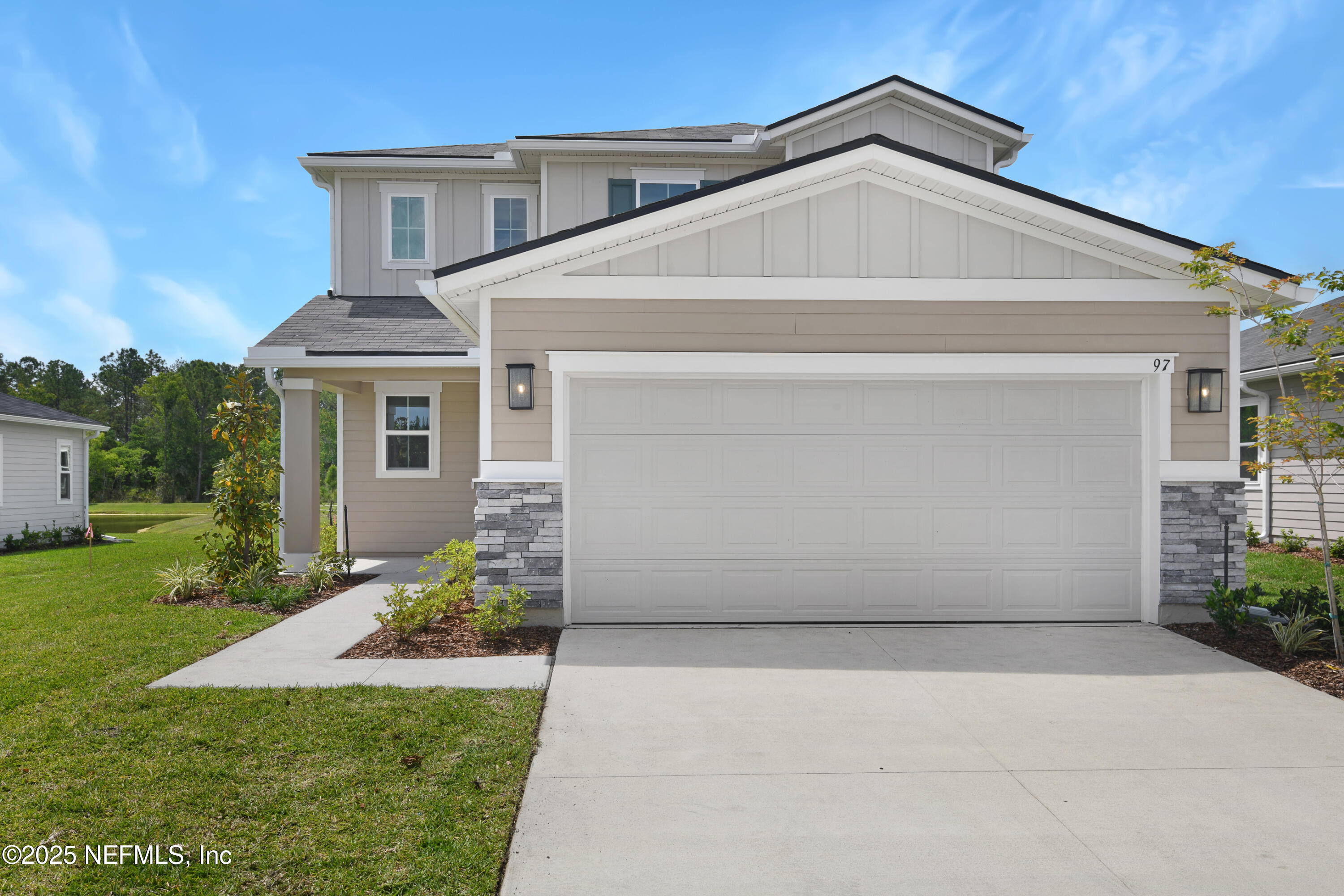97 Arbor Alcove Lane St. Augustine, FL 32084 - Photo 2 of 22 a front view of a house with a yard and garage