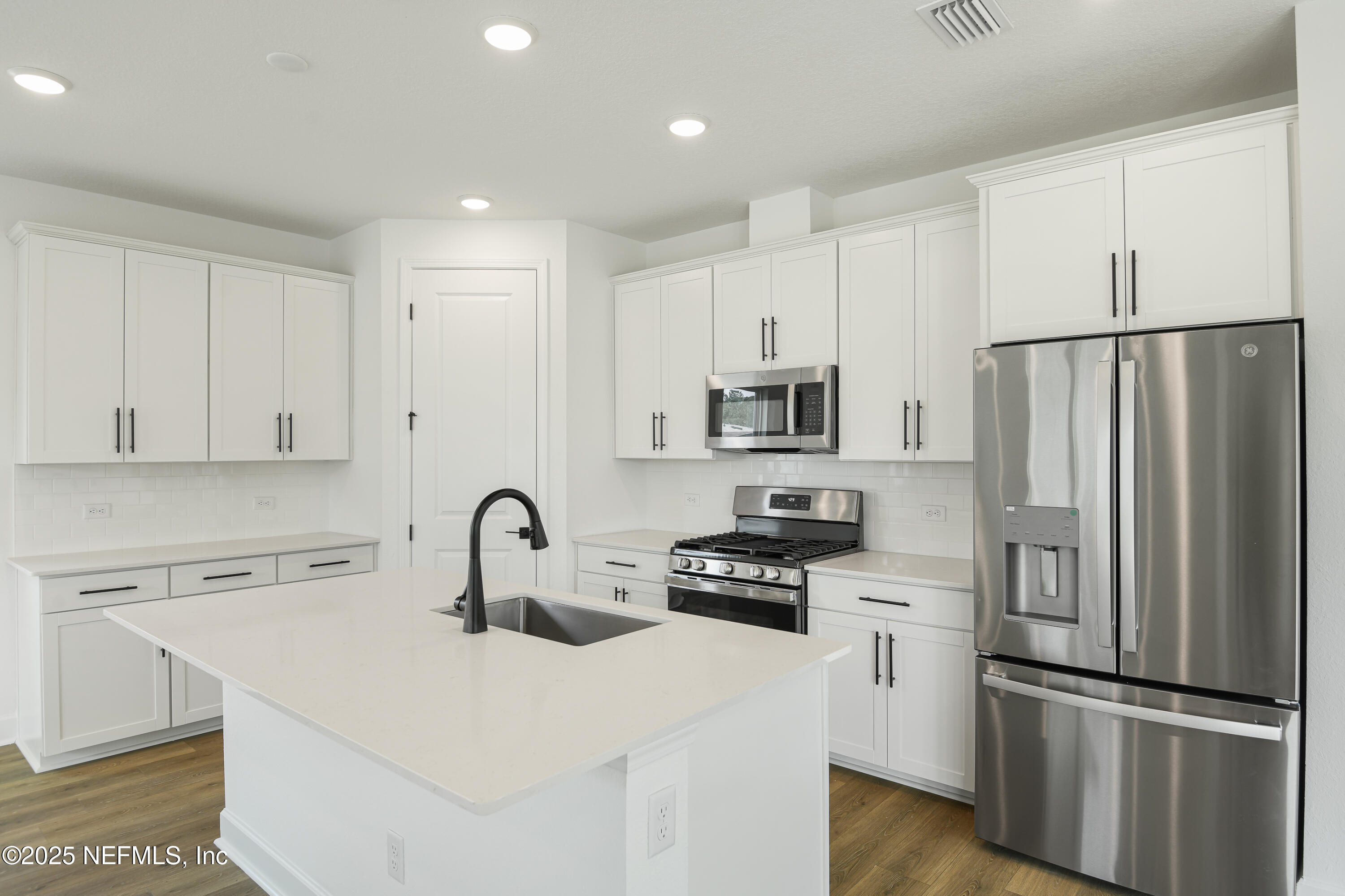 97 Arbor Alcove Lane St. Augustine, FL 32084 - Photo 4 of 22 a kitchen with stainless steel appliances a refrigerator sink and cabinets