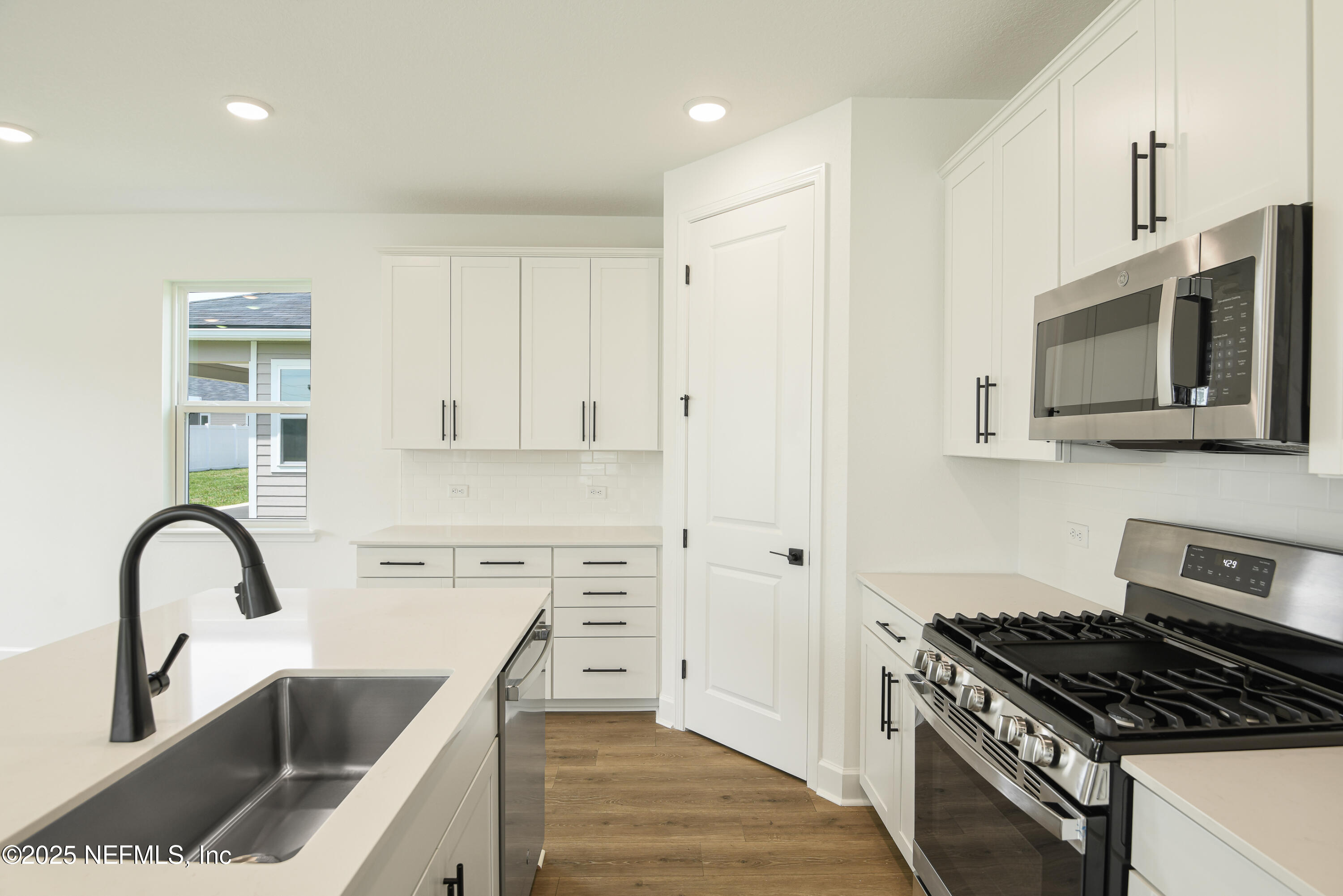 97 Arbor Alcove Lane St. Augustine, FL 32084 - Photo 6 of 22 a kitchen with granite countertop a stove and a sink