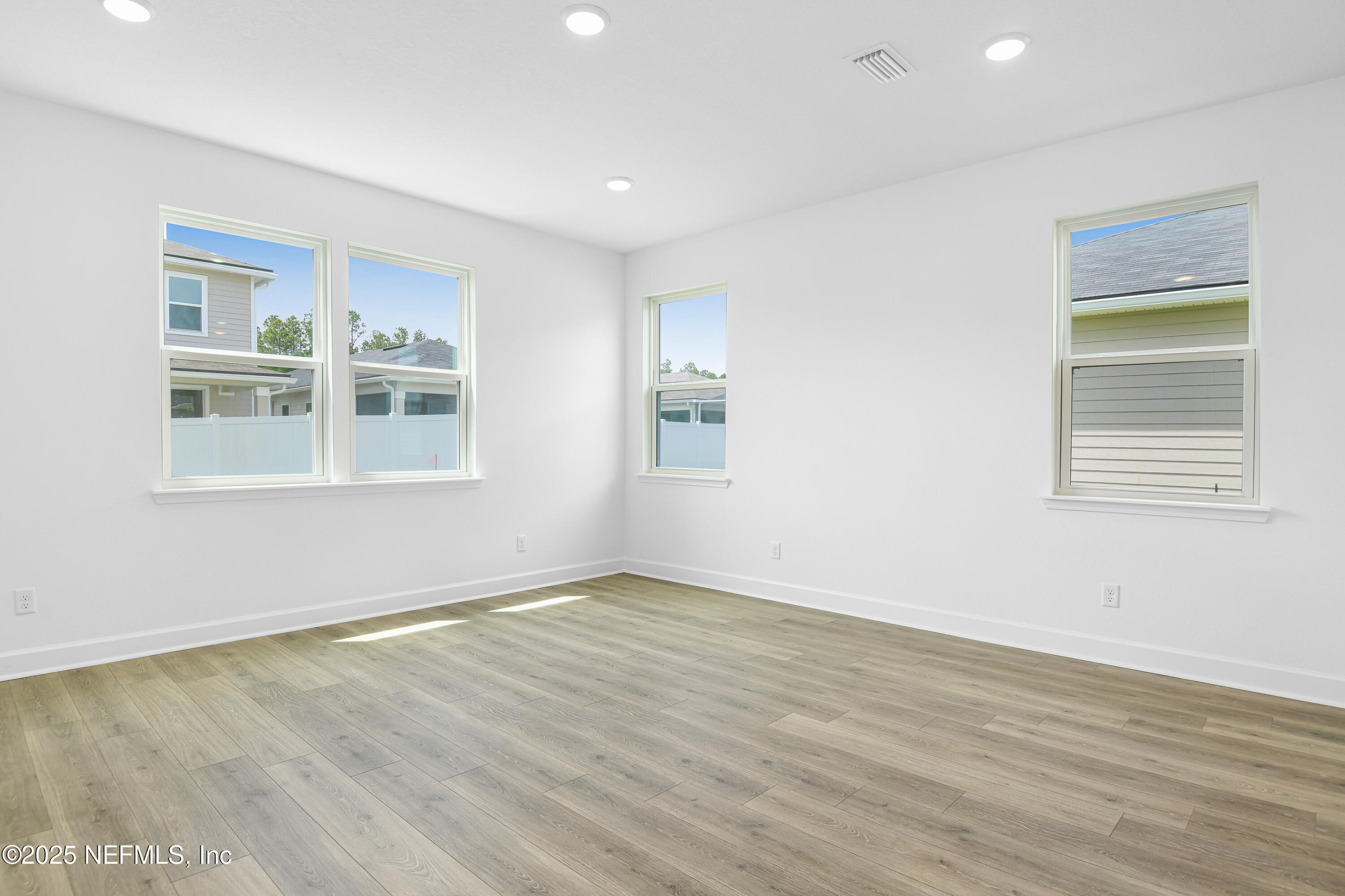 97 Arbor Alcove Lane St. Augustine, FL 32084 - Photo 7 of 22 a view of an empty room with wooden floor and a window