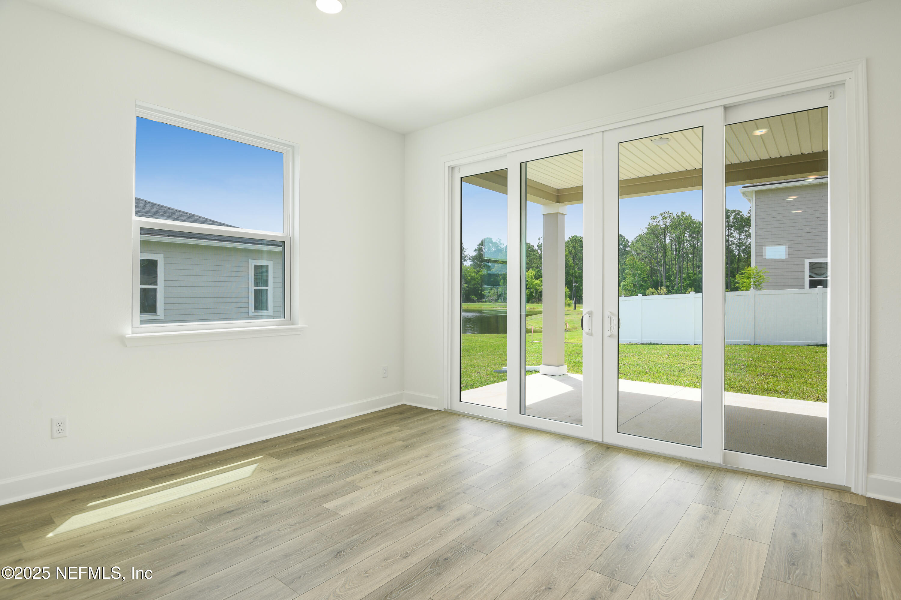 97 Arbor Alcove Lane St. Augustine, FL 32084 - Photo 8 of 22 a view of an empty room with wooden floor and a window