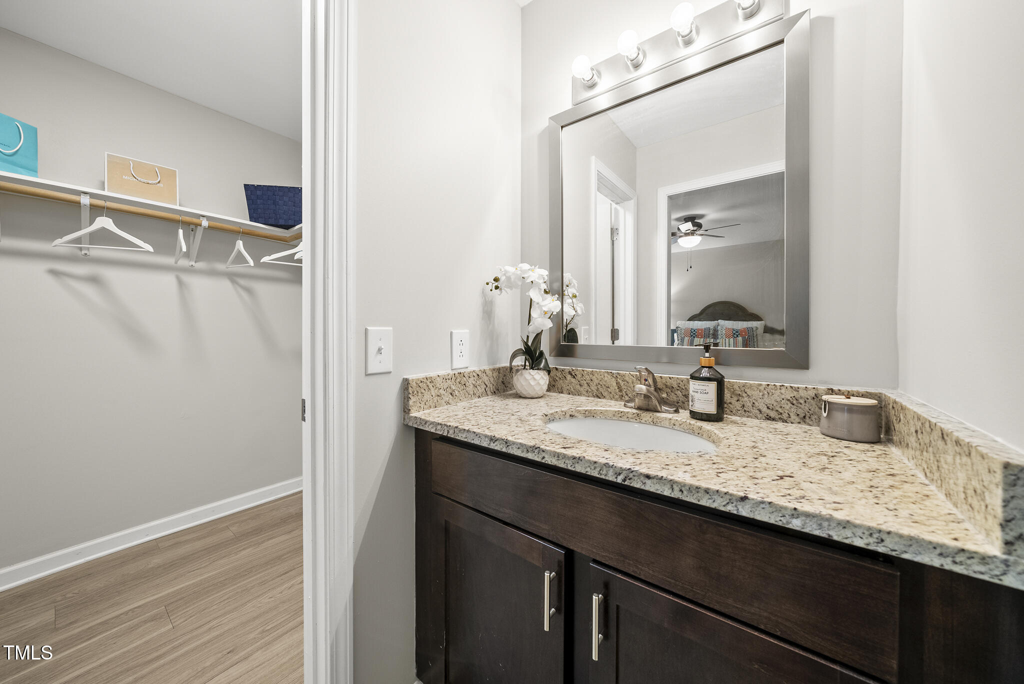 710 Powell Drive, Unit F Raleigh, NC 27606 - Photo 19 of 32 a bathroom with a granite countertop sink and a mirror