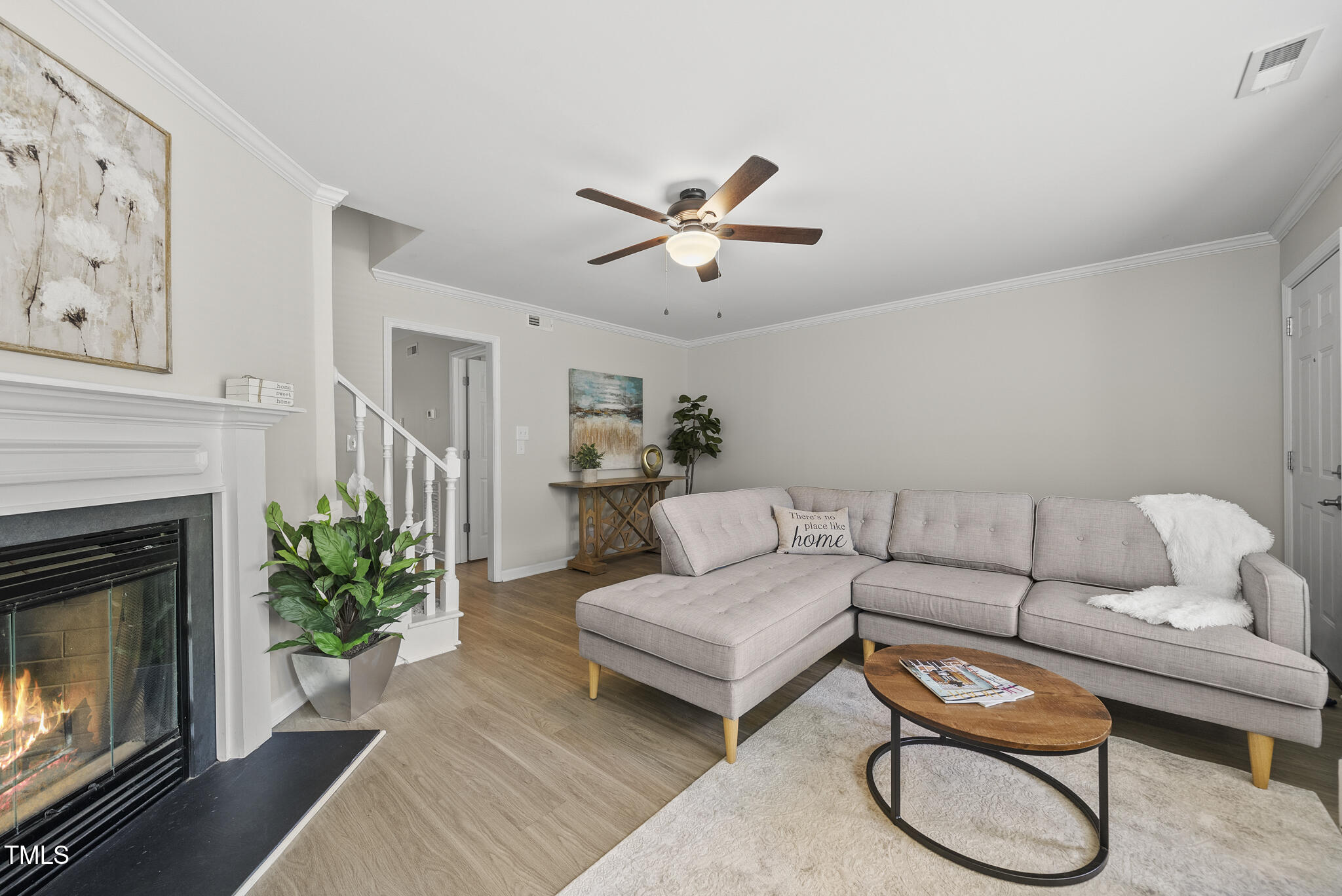 710 Powell Drive, Unit F Raleigh, NC 27606 - Photo 7 of 32 a living room with furniture a fireplace and wooden floor