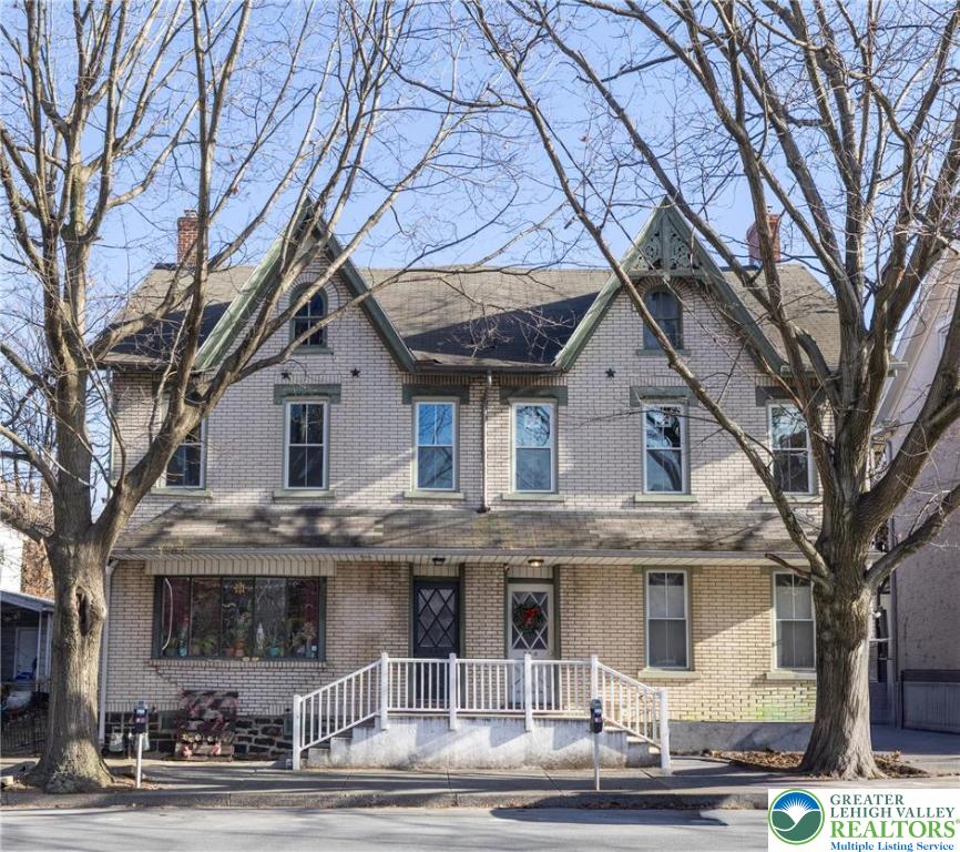 front view of a house with a trees