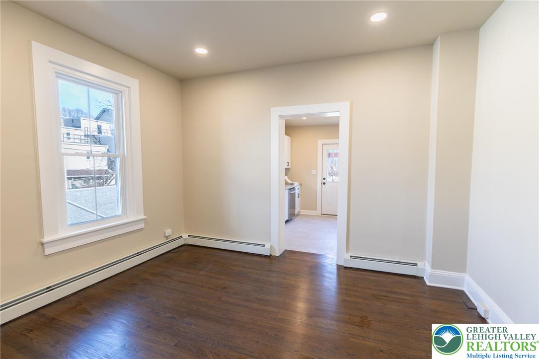 708 Main Street, Unit 2 Bethlehem, PA 18018 - Photo 6 of 18 an empty room with wooden floor and windows