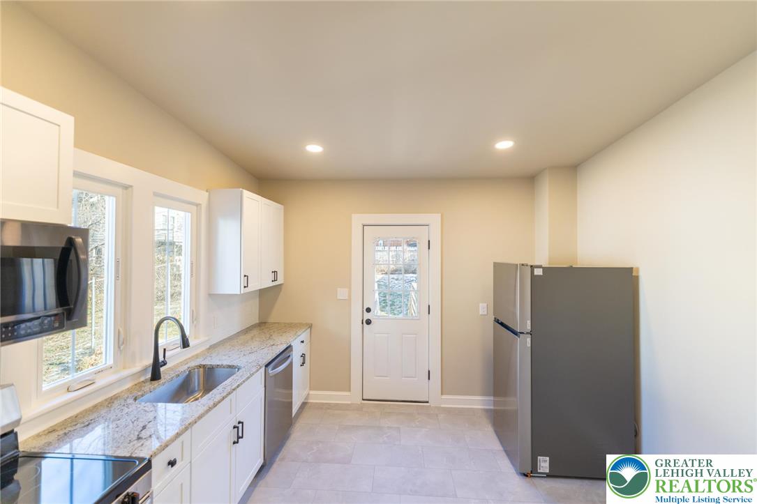 708 Main Street, Unit 2 Bethlehem, PA 18018 - Photo 7 of 18 a large kitchen with a large counter top space appliances and cabinets