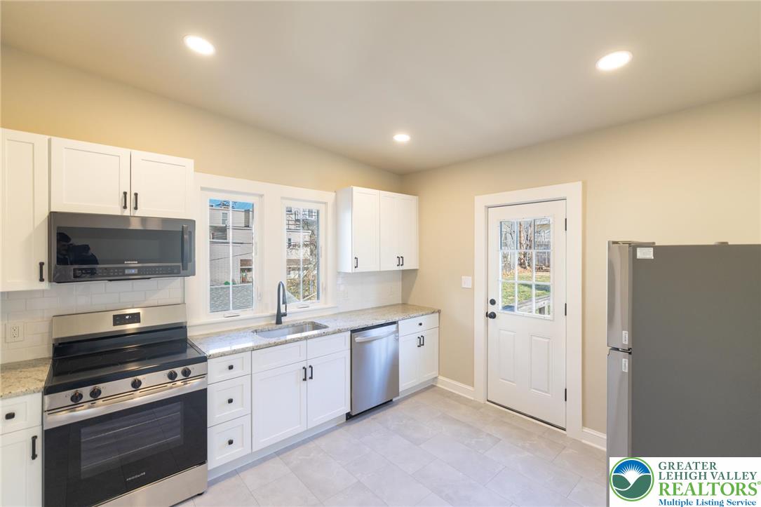 708 Main Street, Unit 2 Bethlehem, PA 18018 - Photo 8 of 18 a kitchen with stainless steel appliances a stove sink and refrigerator