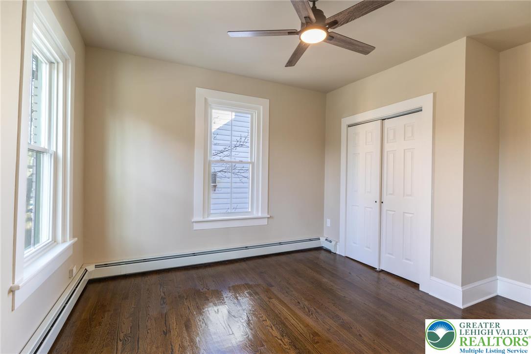 708 Main Street, Unit 2 Bethlehem, PA 18018 - Photo 10 of 18 a view of an empty room with wooden floor and a window