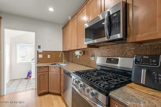 a kitchen with a sink stove and microwave