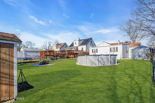 a view of a house with backyard and a patio